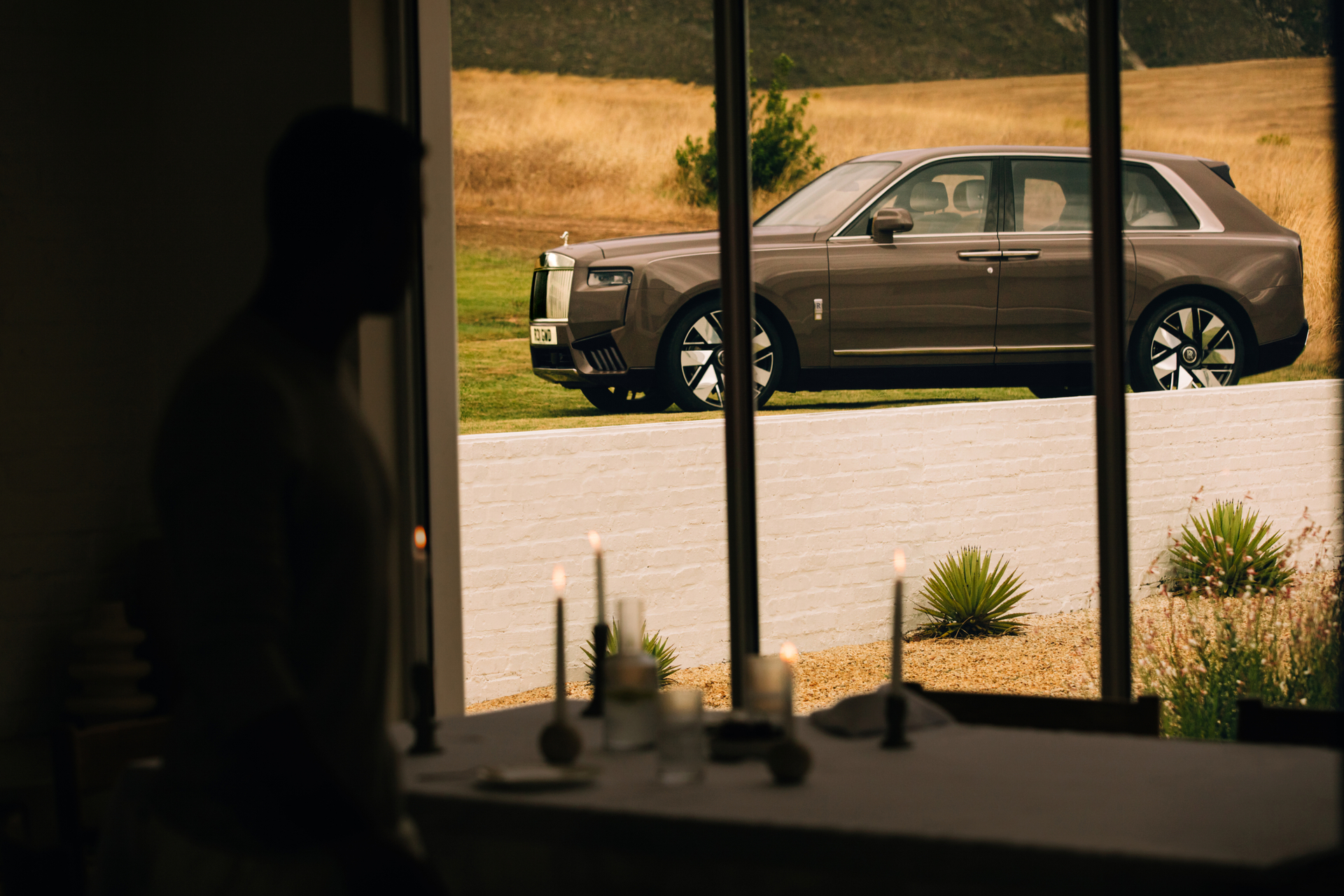 Side view of a Rolls-Royce Cullinan Series II throw a window
