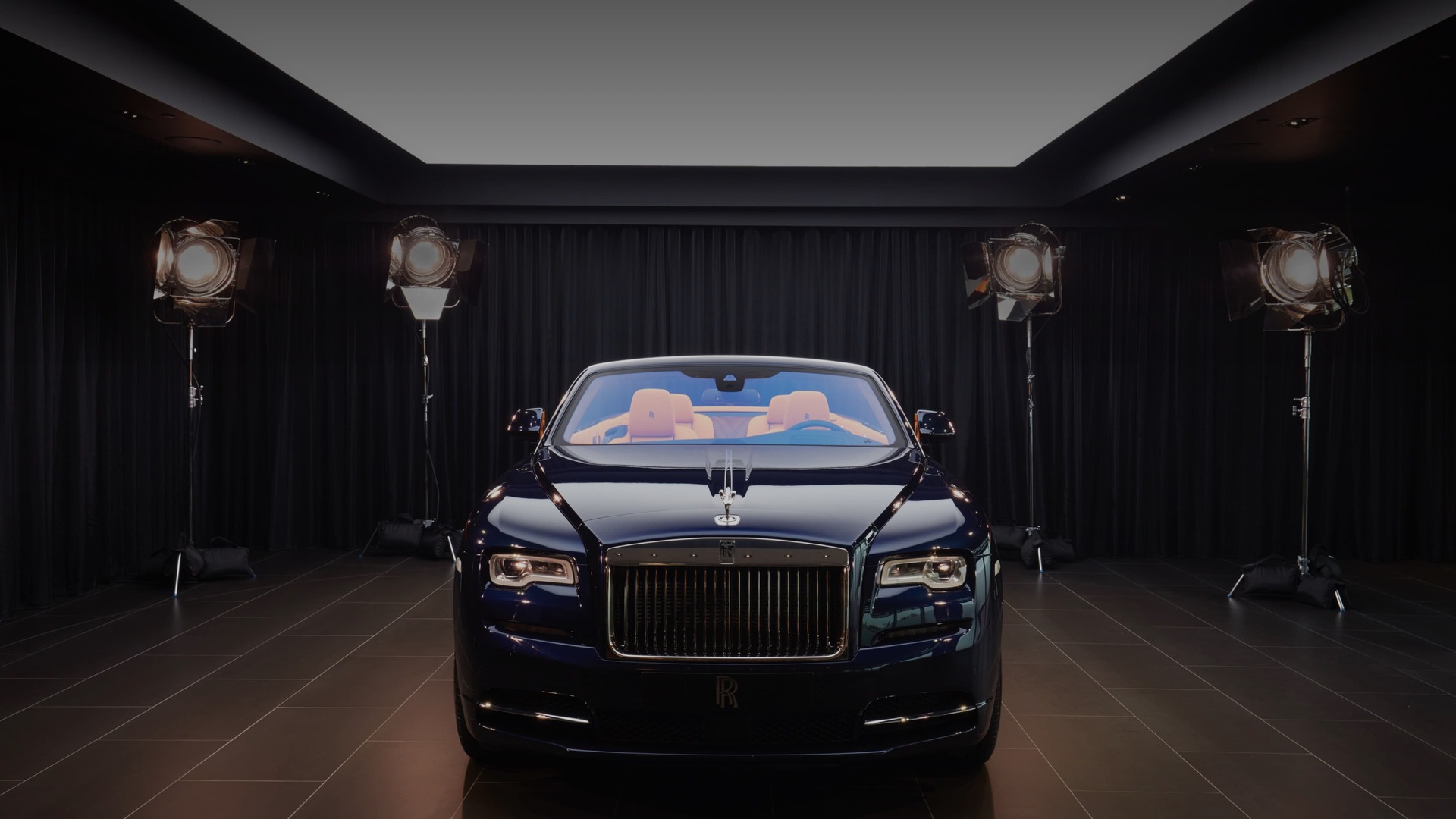 rolls royce wraith on sale Front exterior of stationary Rolls-Royce motor car in showroom space