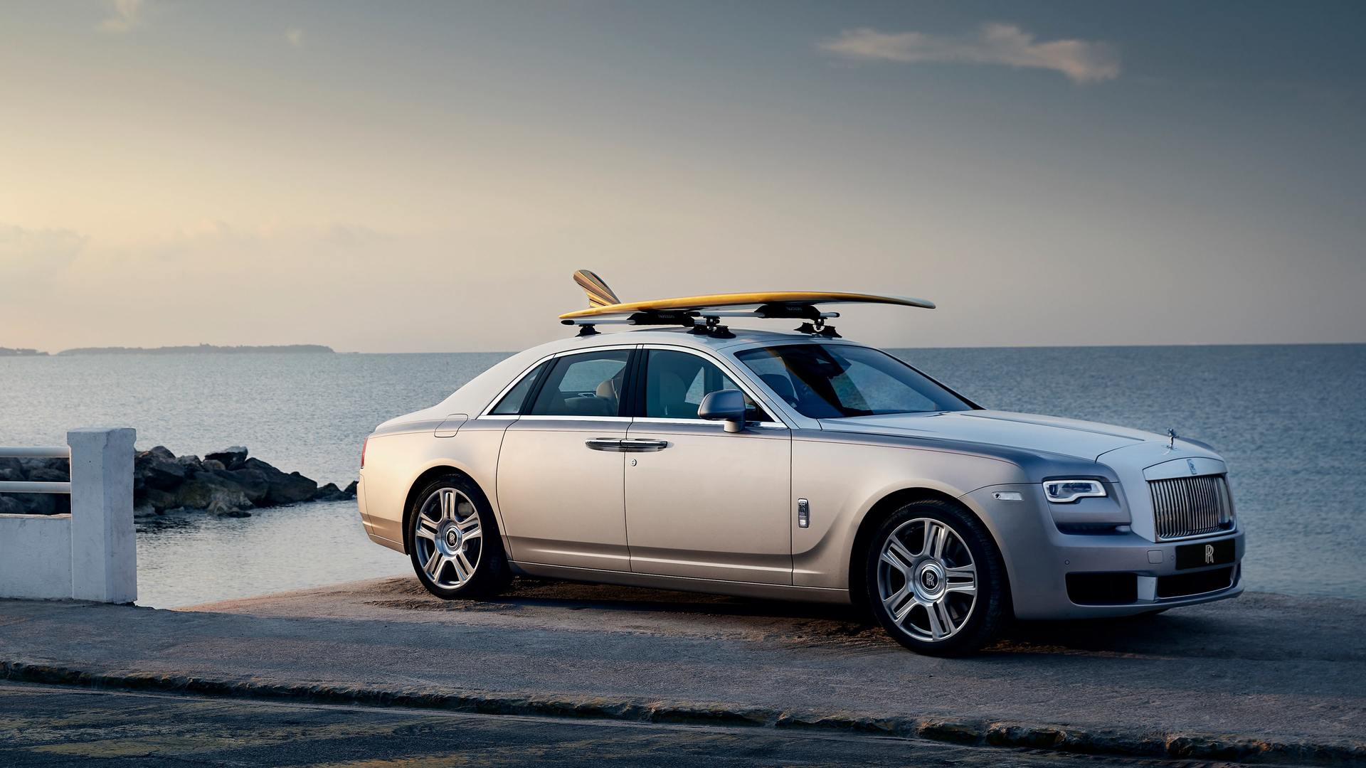 A grey Rolls-Royce car near the sea