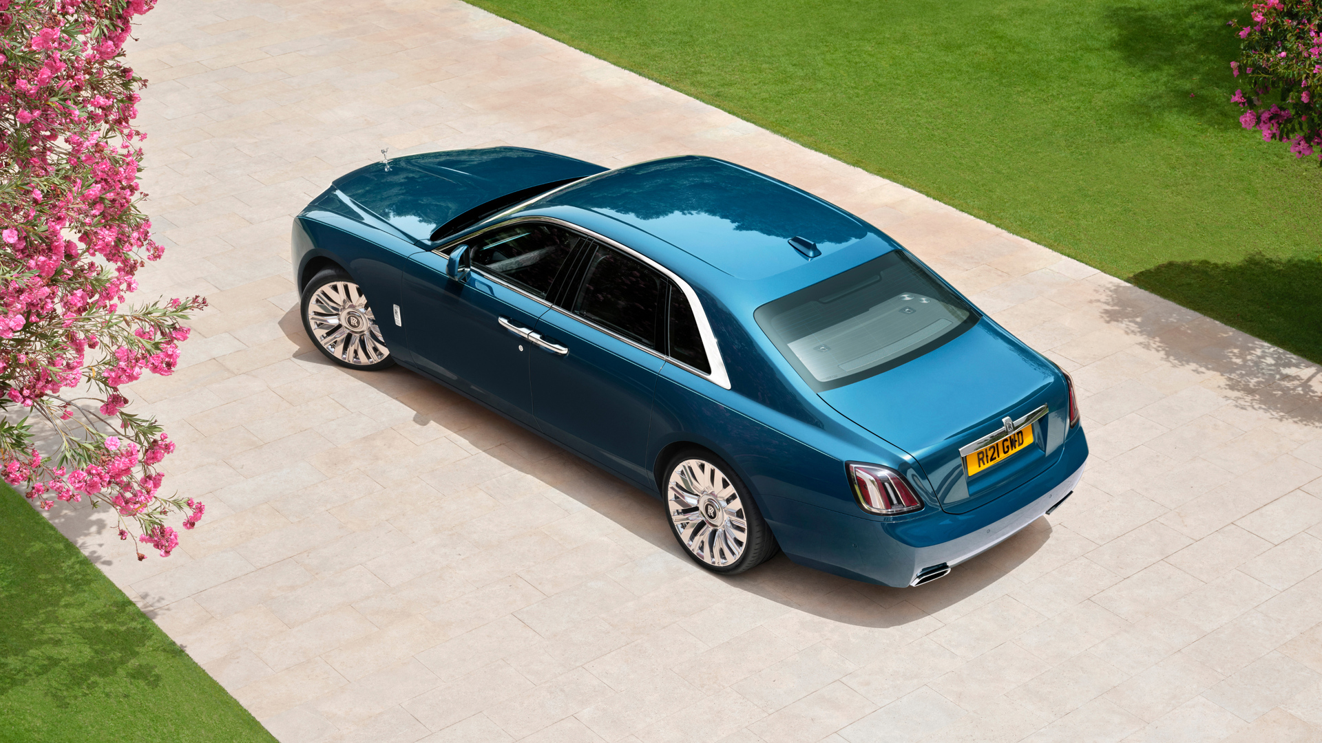 Ariel shot of a blue Ghost Series II on a brick paved road.