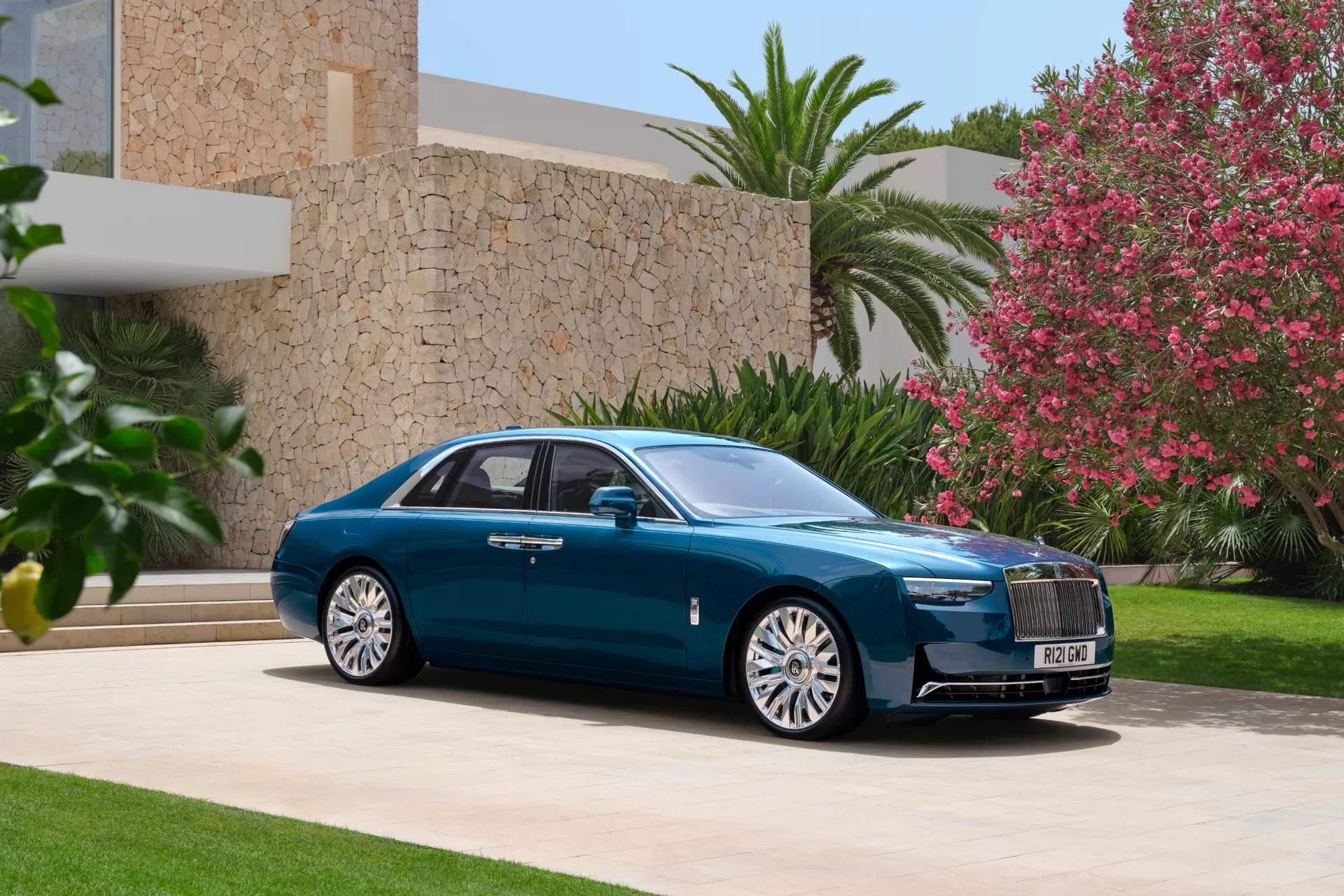 Hero image of the whole GSII side view sitting outside of a modern house with beautiful landscape. 
