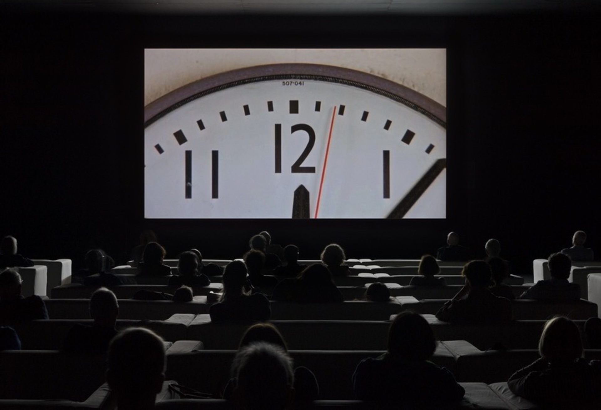 Christian Marclay’s Clock image. Crowd watching a film