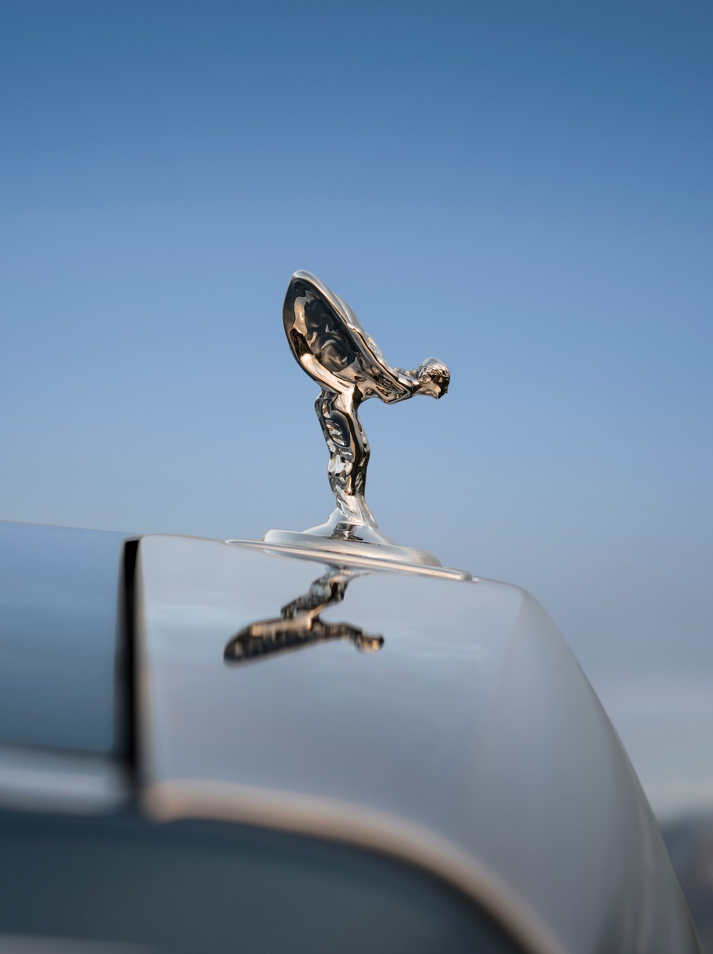 Close up of the Spirit of Ecstasy on the deep blue Phantom Extended.