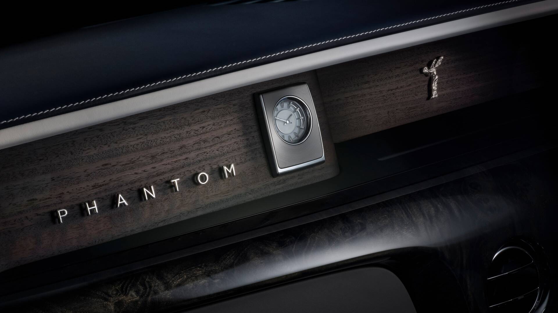 Image of the interior Phantom Extended dashboard, showing the wood interior with the famous Rolls-Royce clock. 