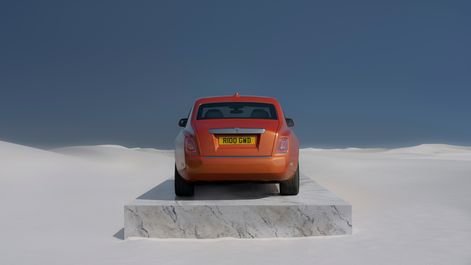 Rear of an Orange Phantom on a slab of marble in the middle of the desert 