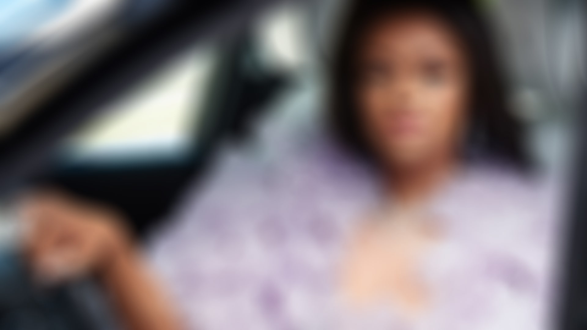 A profile shot of Ella Peters taken through the drivers window of her Rolls-Royce Phantom