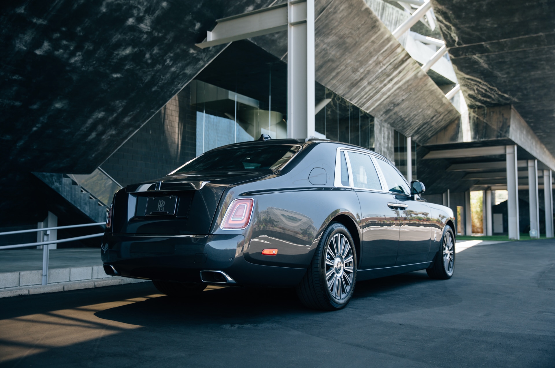 A rear shot of the Rolls-Royce Phantom, showing the right hand side of the car surrounded by geometric angled architecture