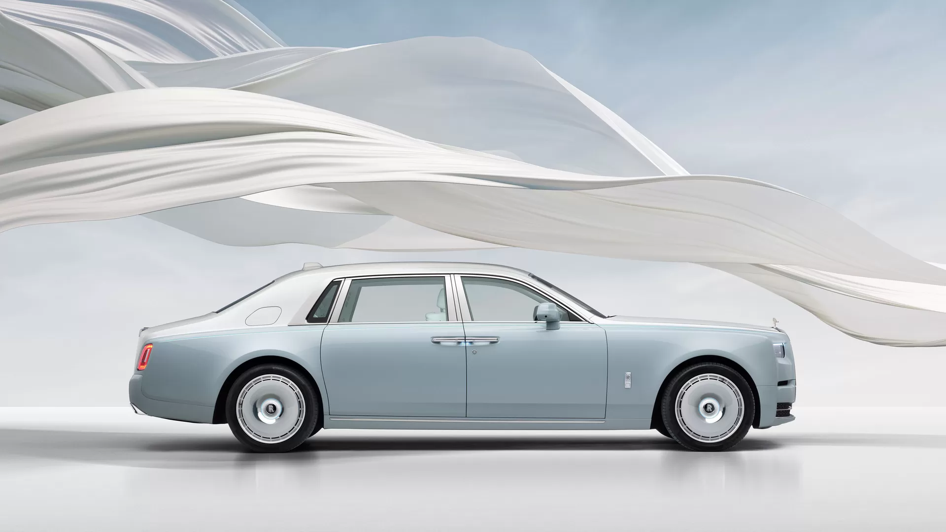 Phantom Scintilla full car image with the white ribbon circling it with the blue sky in the background. 
