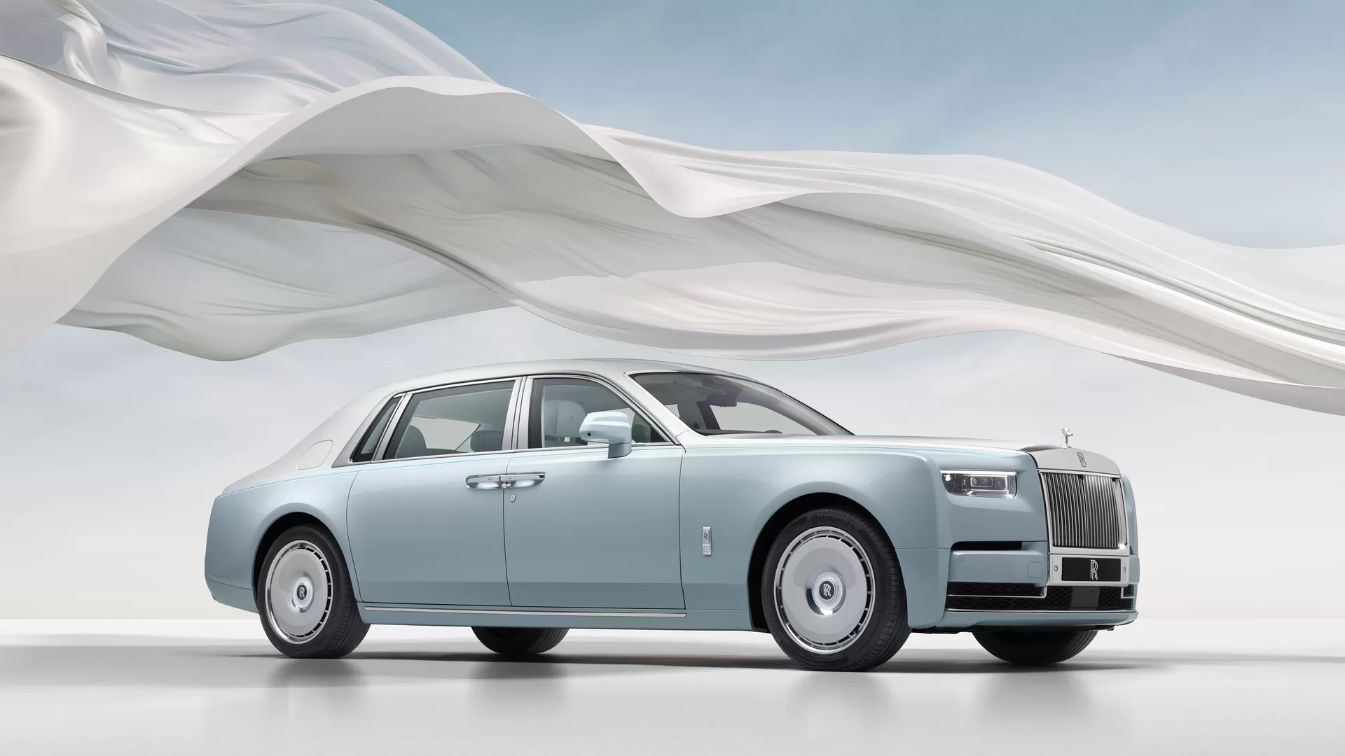 Phantom Scintilla full car image with the white ribbon circling it with the blue sky in the background. 