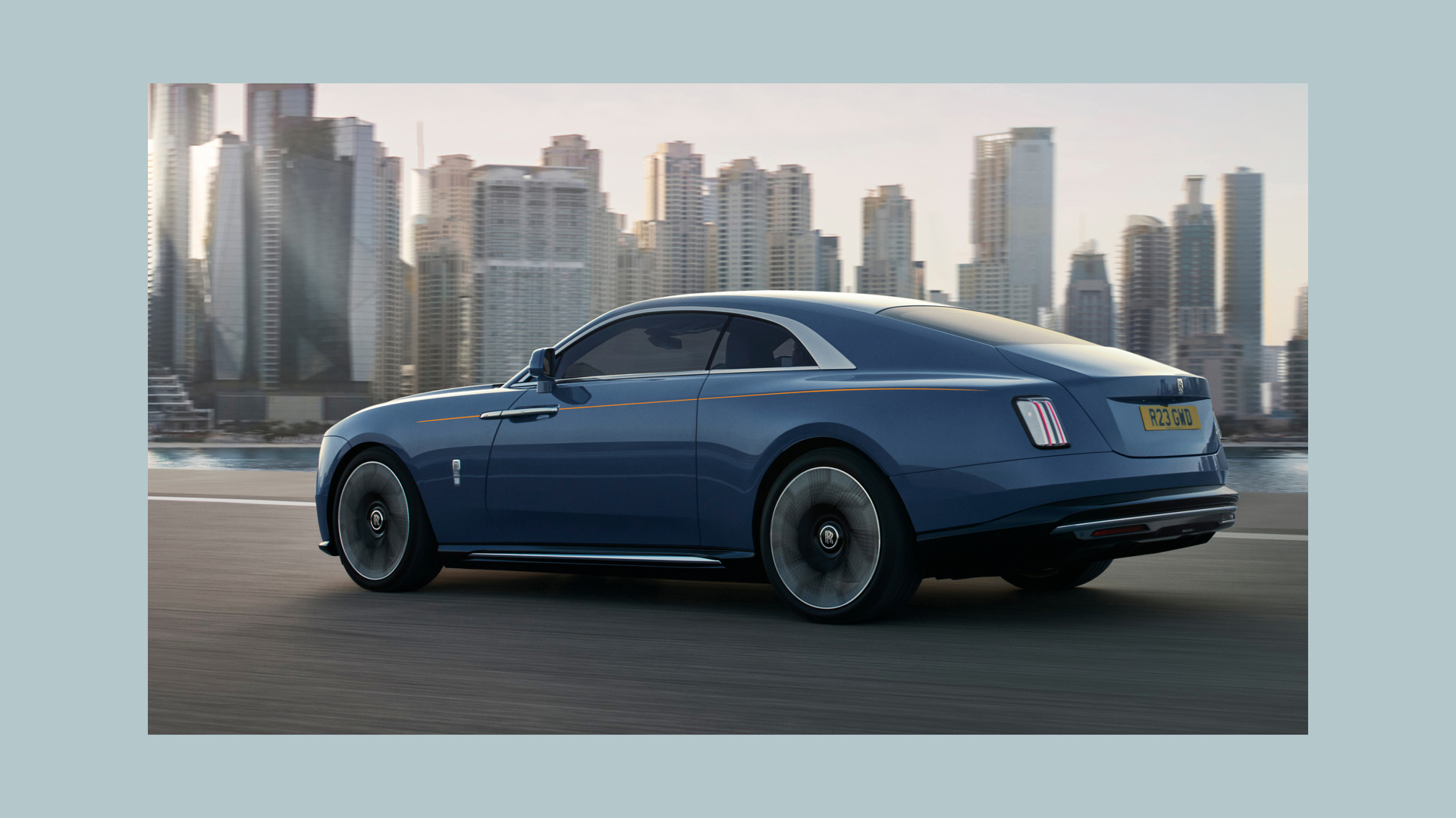 Side view of the Rolls-Royce Spectre car driving in the city
