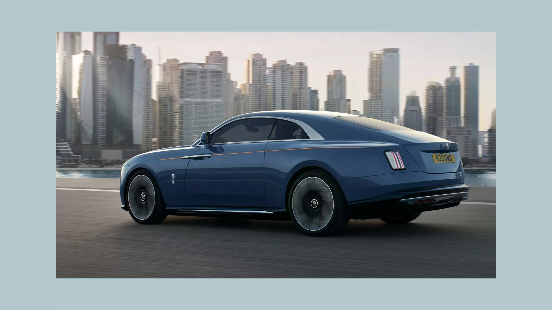 Side view of the Rolls-Royce Spectre car driving in the city