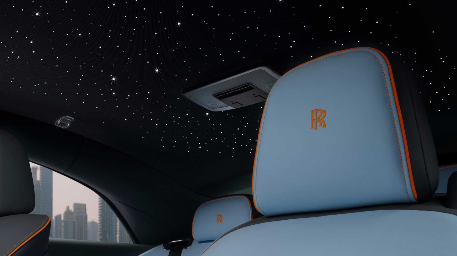 Close up shot of inside of the Spectre. Showcasing the stars in the roof, and a blue and orange seat.