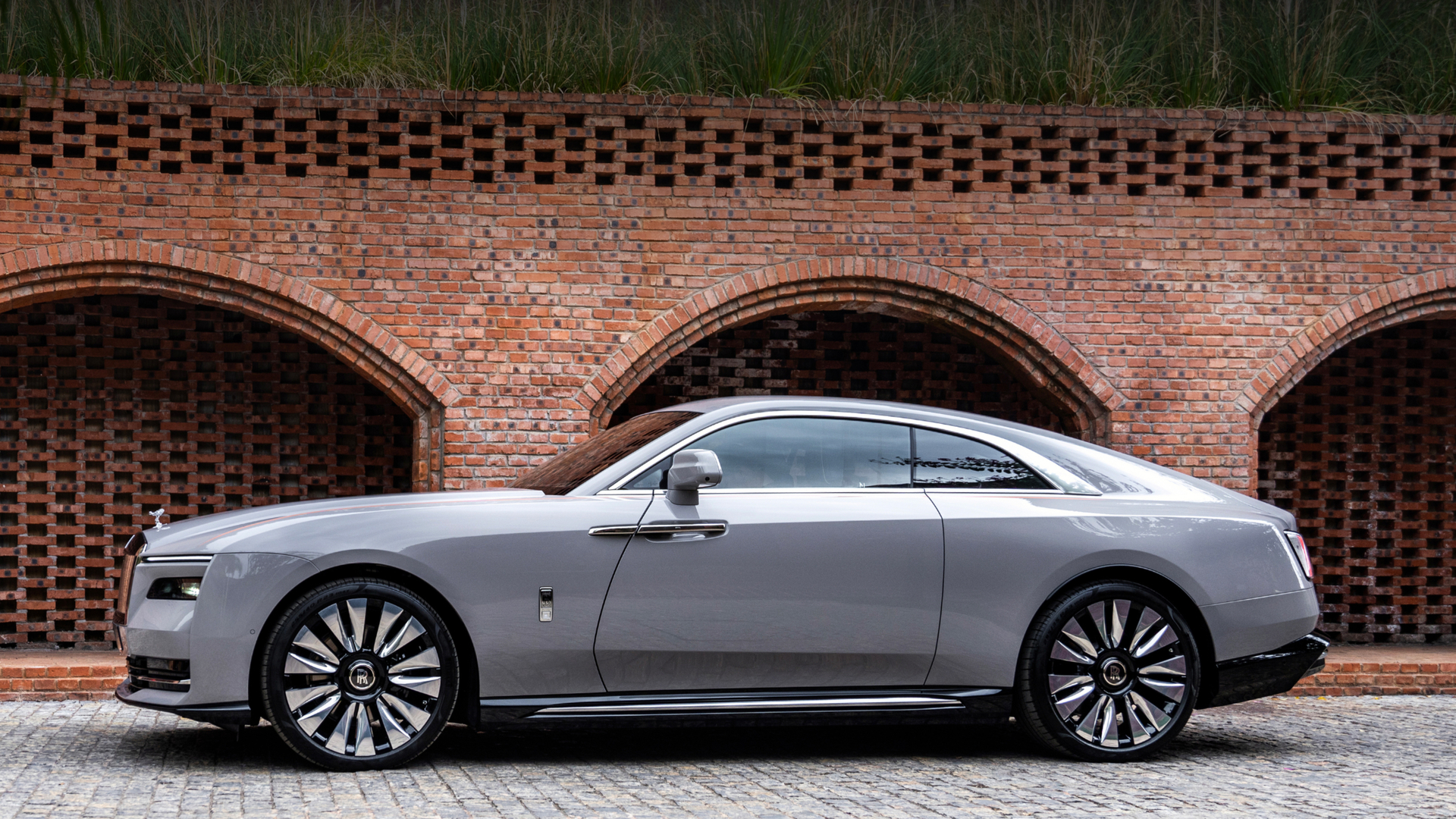 Image of a grey Spectre sitting on a brick road.