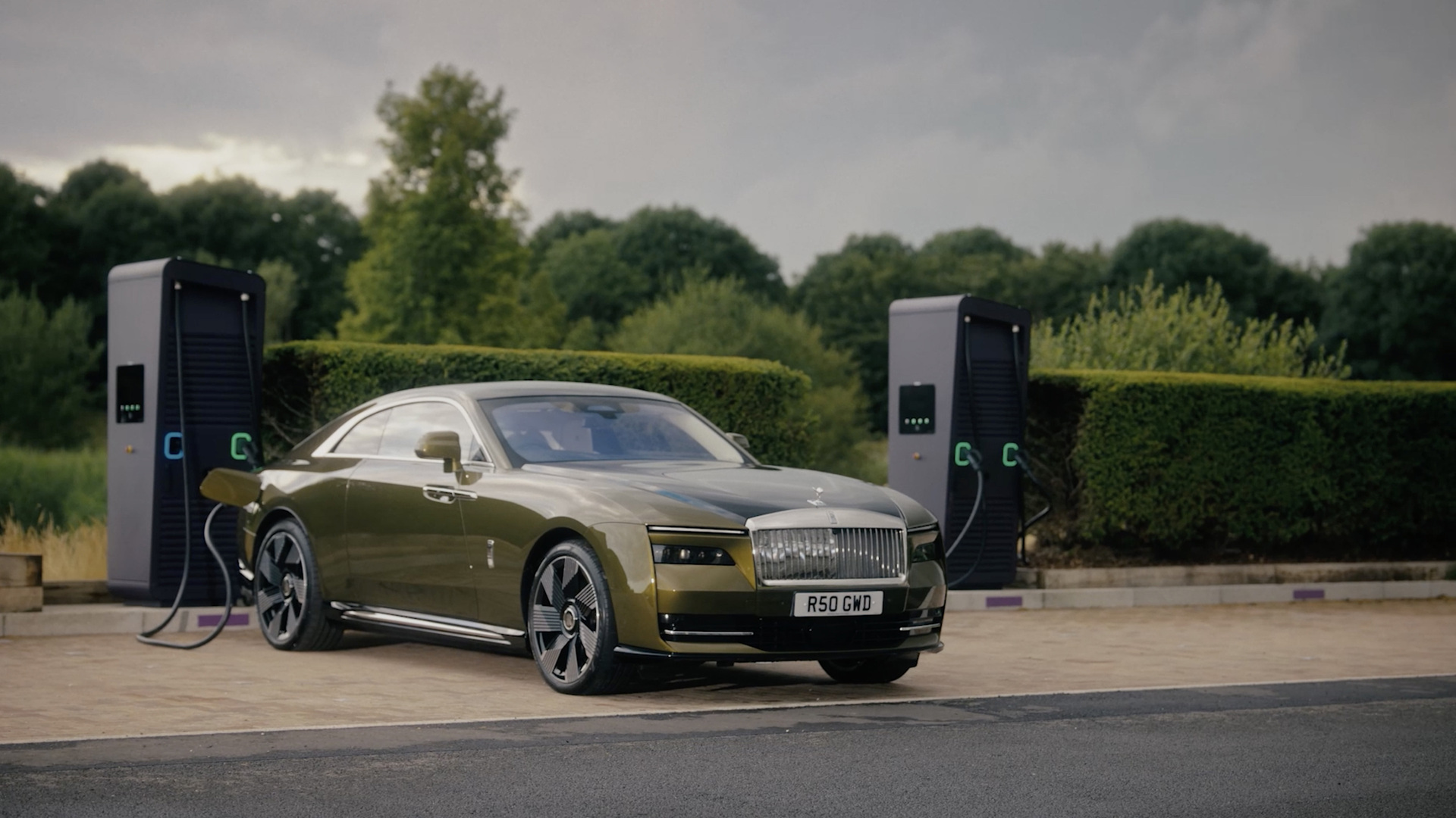 Front three quarter view of Spectre charging at a public charging station