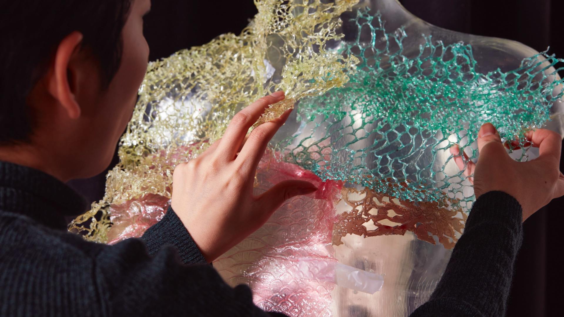 Hands of Scarlett Yang working on her artwork